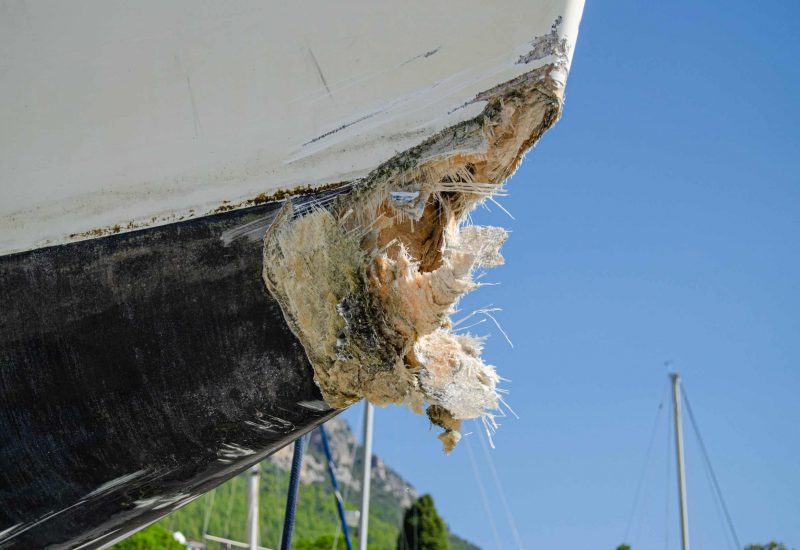 The collision-damaged bow of the fiberglass yacht